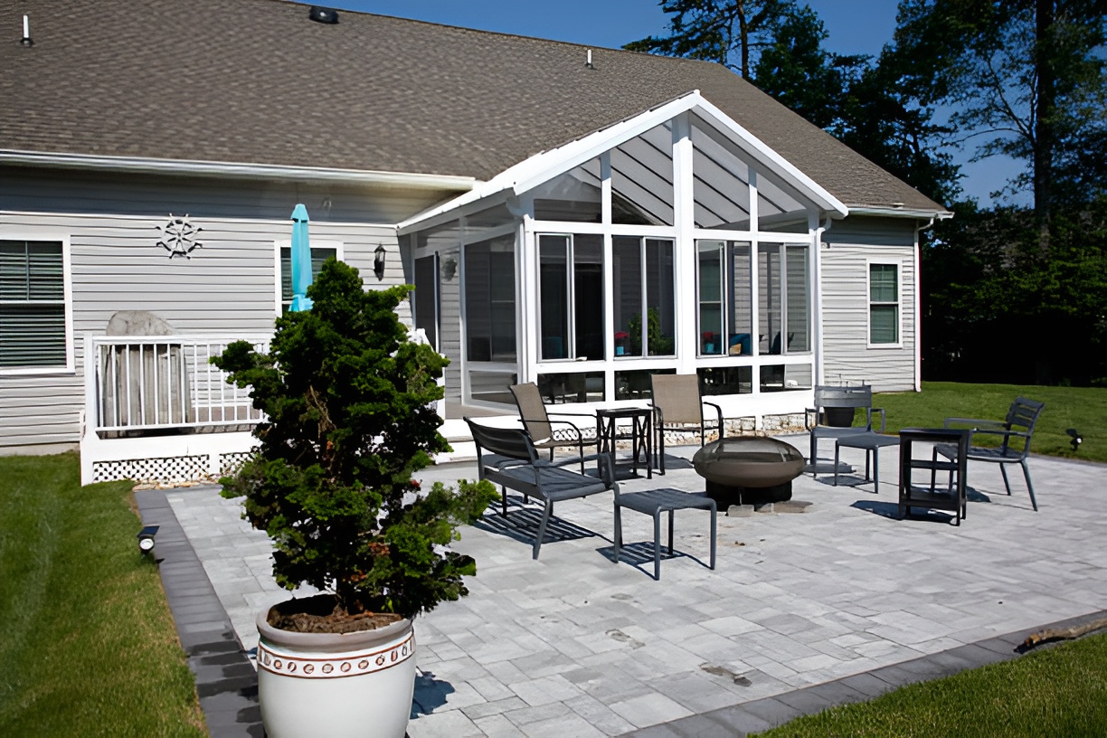 backyard featuring a sunroom and a concrete patio